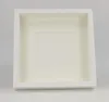 A white shadow box frame with a cream-colored matting is shown against a light gray background. Produktbild-Vorschau