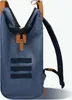 A close-up view of a blue backpack with brown leather accents. Voir les images du produit
