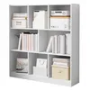 A white, multi-compartment bookshelf filled with books, boxes, and decorative items. Produktbild-Vorschau