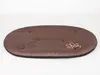 A brown oval dog bed with a paw print logo on a white background. Produktbild-Vorschau