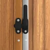 A close-up view of a black latch mechanism on a wooden surface, with a silver strip running vertically. Produktbild-Vorschau