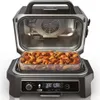 An open electric grill with a tray of chicken wings inside. Voir les images du produit