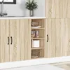 A close-up view of a kitchen cabinet with a sink and a plant in the background. Náhľad obrázku produktu
