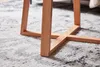 Close-up of wooden furniture legs resting on a patterned rug. Anteprima dell’immagine prodotto