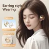 A woman with her eyes closed is wearing gold and white earbuds. Text overlays describe the product's features. Náhľad obrázku produktu