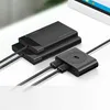 A black USB hub and two black external hard drives are arranged on a white surface, with cables connecting them. Náhľad obrázku produktu