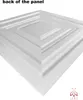 A close-up, angled view of the back of a white decorative panel with a stepped square pattern. Anteprima dell’immagine prodotto