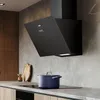 A modern kitchen scene with a black range hood over a stovetop with a blue pot. Voir les images du produit