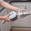A person is holding a handheld vacuum cleaner in a kitchen. Anteprima dell’immagine prodotto