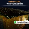 A wooden shed decorated with strings of warm white LED lights on the roof and hanging down from the eaves. Produktbild-Vorschau