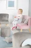 A young child sits on a pink sofa in a room with other child-sized furniture. Voir les images du produit