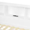 A close-up view of a white bed frame with built-in shelving and a black USB port. Náhled obrázku produktu
