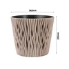 A sandy-colored plant pot with a wavy texture and a black inner liner, shown with dimensions indicated by measurement lines and text. Voir les images du produit