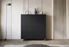 A modern living room setting with a black cabinet and a floor lamp. Voir les images du produit