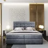 A modern bedroom with a large upholstered bed as the focal point. Produktbild-Vorschau