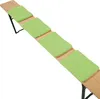 A long wooden bench with four green seat cushions placed on it. Produktbild-Vorschau