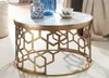 A round coffee table with a marble top and a gold geometric base, decorated with vases and a teacup. Produktbild-Vorschau
