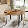 A round dining table with four chairs set in a dining room. Podgląd zdjęcia produktu