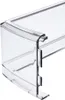 A close-up of a clear plastic refrigerator door shelf. Voir les images du produit