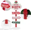 A Christmas-themed LED signpost with multiple directional signs pointing to various North Pole locations. Podgląd zdjęcia produktu