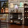 A bar cart is set up in a room with a brick wall and a window showing a nighttime scene with lights. Podgląd zdjęcia produktu