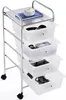 A white four-drawer rolling cart with chrome accents, displayed on a white background. Some items are visible inside the drawers, including a book, a camera lens, a game controller, and keys. Podgląd zdjęcia produktu