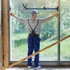 A person is measuring a window frame with a tool. Náhled obrázku produktu
