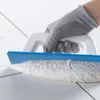 A gloved hand is using a trowel to apply grout to tile. Anteprima dell’immagine prodotto