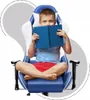 A young boy is sitting cross-legged in a blue and white gaming chair, holding a blue book in front of his face. Anteprima dell’immagine prodotto