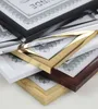 A stack of four picture frames in different colors and finishes, each containing a certificate or document. Produktbild-Vorschau