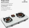 A close-up, slightly angled shot of a white glass gas cooktop with three burners. The burners have different power ratings indicated in orange text. The KLARSTEIN logo is visible in the top right corner. Náhľad obrázku produktu