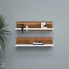 Two modern shelves mounted on a gray wall, decorated with minimalist figures and books. Produktbild-Vorschau