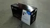 A black HP LaserJet toner cartridge box is placed on a gray concrete floor. Produktbild-Vorschau