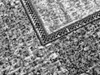 A close-up view of a carpet with a patterned border. Náhled obrázku produktu