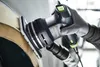 A gloved hand is holding and operating a Festool sander on a curved surface. Produktbild-Vorschau