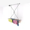 A ceiling-mounted clothes drying rack with clothes hanging on it. Anteprima dell’immagine prodotto
