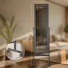 A full-length mirror with dimensions indicated, placed in a room with furniture in the background. Náhled obrázku produktu