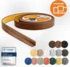 A roll of brown self-adhesive trim with a sample piece in the foreground, and a selection of color swatches below. Anteprima dell’immagine prodotto