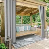 An outdoor gazebo with a swing seat, rug, and curtains. Produktbild-Vorschau