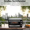 A mini oven is placed on a table with a city skyline in the background. Produktbild-Vorschau