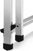 Close-up view of the bottom section of an aluminum ladder, showing the connection points between the legs and the anti-slip feet. Náhled obrázku produktu