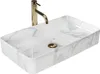 A rectangular white basin with a marble-like pattern and a gold faucet. Podgląd zdjęcia produktu