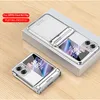 A silver flip phone case is displayed on a white box, with another phone case in the foreground on a wooden surface. Produktbild-Vorschau