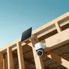 A solar-powered security camera mounted on wooden framing under a blue sky. Náhľad obrázku produktu