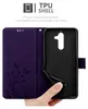 A hand is holding a purple phone case open, showing the inside and the phone holder. Náhled obrázku produktu