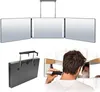 A collage of images showing a tri-fold mirror with LED lights, a folded mirror with a hook, and a person using a trimmer to cut their hair, viewed in a mirror. Produktbild-Vorschau