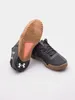 A pair of black Under Armour sports shoes are shown against a white background. Anteprima dell’immagine prodotto