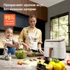 A woman and child are preparing food in a kitchen, with a white air fryer on the counter. The scene is brightly lit and appears to be a promotional image. Náhľad obrázku produktu