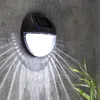 A solar-powered wall light illuminates a textured concrete wall, casting a patterned light. Produktbild-Vorschau