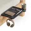 A bedside tray with a notebook, pen, watch, and cup holder attached to a wooden bed frame. Produktbild-Vorschau